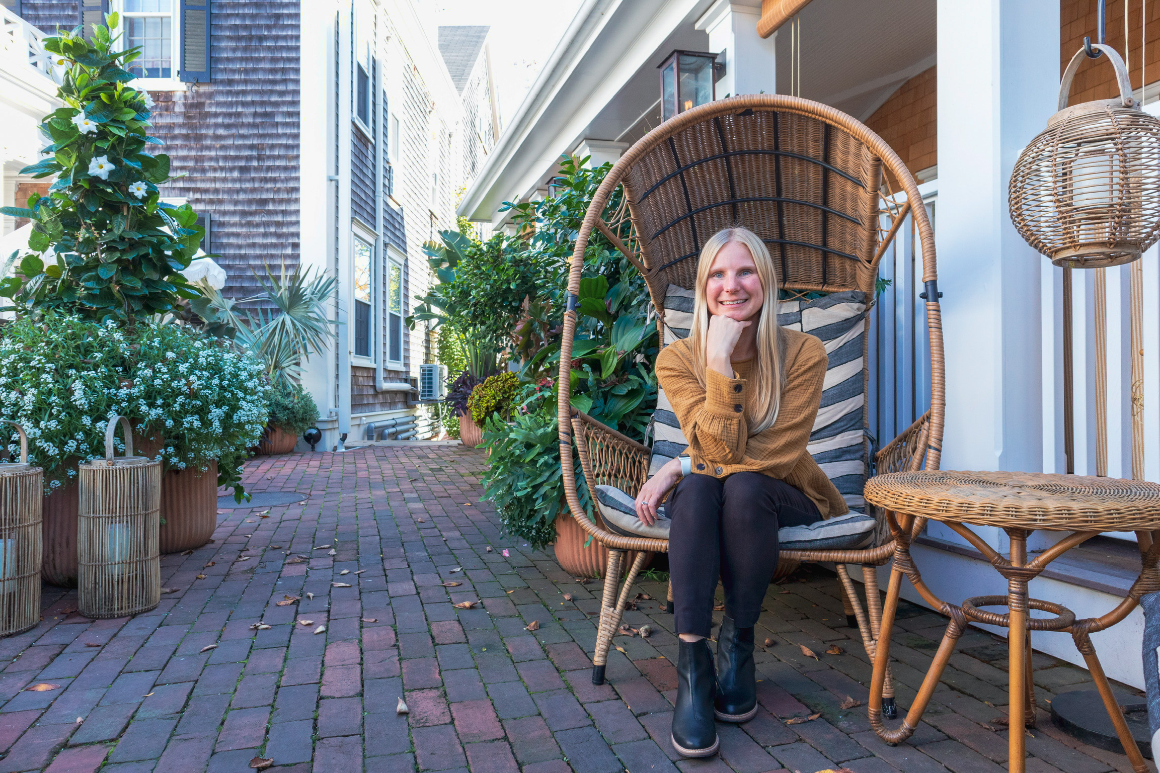 Functional Medicine Provider Alison Percowycz, MSN, FNP-C sitting in courtyard smiling in Denver Colorado