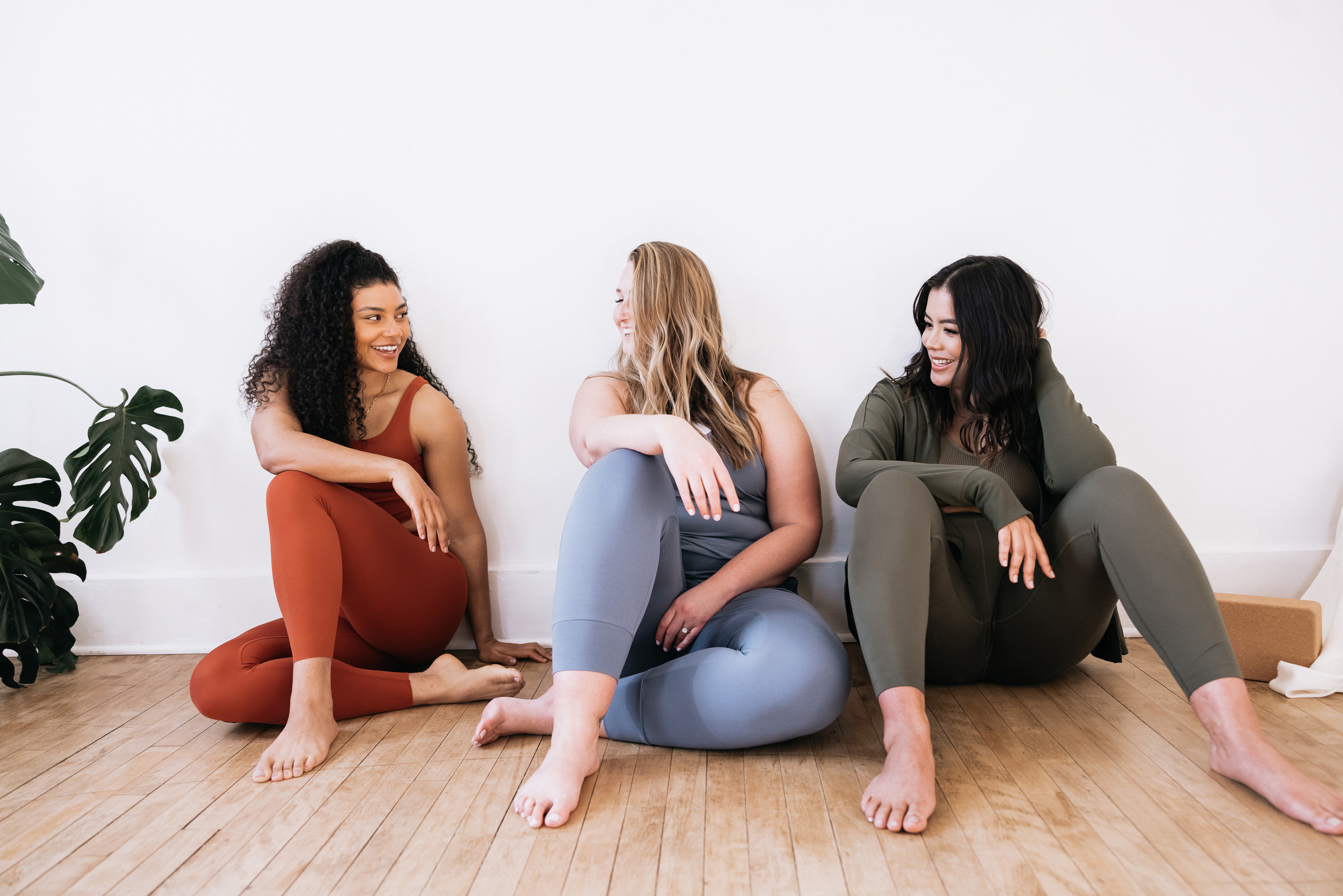 women sitting in yoga studio fitness health and wellness